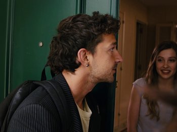 Movie still from “American Honey” (2016), directed by Andrea Arnold – A young man with long black hair wearing a black jacket; Close Up shot, Over the shoulder angle