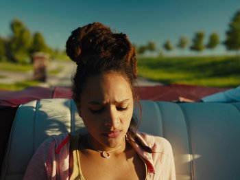 Movie still from “American Honey” (2016), directed by Andrea Arnold – A young woman with her eyes closed sitting in a car; Close Up shot, Low angle