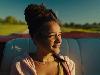 Movie still from “American Honey” (2016), directed by Andrea Arnold – A woman sitting in a car with her eyes closed; Close Up shot, Low angle