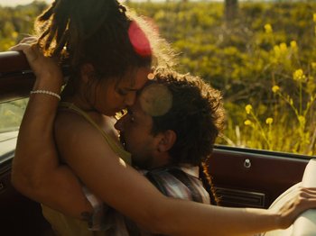 Movie still from “American Honey” (2016), directed by Andrea Arnold – A man and a woman hugging in a car; Medium shot, Overhead angle