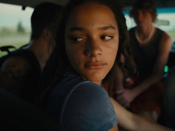 Movie still from “American Honey” (2016), directed by Andrea Arnold – A young girl is looking at the camera; Close Up shot, Over the shoulder angle