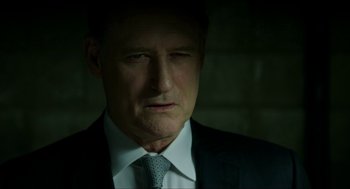 Movie still from “American Ultra” (2015), directed by Nima Nourizadeh – A person wearing a suit and tie; Close Up shot, Over the shoulder angle