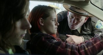 Movie still from “American Ultra” (2015), directed by Nima Nourizadeh – A woman sitting in the back seat of a car talking to two men; Medium shot, Over the shoulder angle