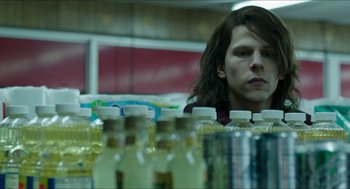 Movie still from “American Ultra” (2015), directed by Nima Nourizadeh – A man sitting in front of a row of bottled water; Medium shot, Low angle