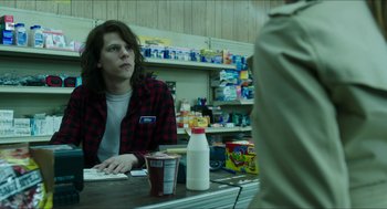 Movie still from “American Ultra” (2015), directed by Nima Nourizadeh – A man sitting at a counter in a grocery store; Medium shot, Over the shoulder angle
