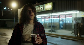 Movie still from “American Ultra” (2015), directed by Nima Nourizadeh – A man with long hair is holding a cup of coffee; Medium shot, Over the shoulder angle