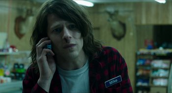 Movie still from “American Ultra” (2015), directed by Nima Nourizadeh – A man with long hair talking on a cell phone; Close Up shot, Over the shoulder angle