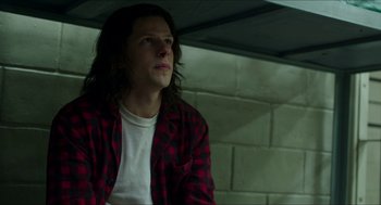 Movie still from “American Ultra” (2015), directed by Nima Nourizadeh – A man with long hair wearing a red and black plaid shirt; Medium shot, Low angle