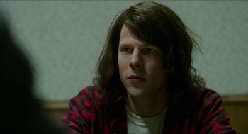 Movie still from “American Ultra” (2015), directed by Nima Nourizadeh – A man with long brown hair sitting in front of a wall; Close Up shot, Over the shoulder angle