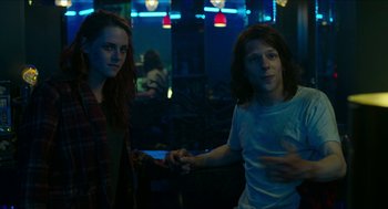 Movie still from “American Ultra” (2015), directed by Nima Nourizadeh – A man and a woman holding hands in a room; Medium shot, Over the shoulder angle