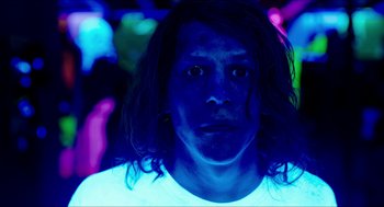 Movie still from “American Ultra” (2015), directed by Nima Nourizadeh – A man with long black hair is in the dark; Close Up shot, Low angle