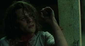 Movie still from “American Ultra” (2015), directed by Nima Nourizadeh – A man with a knife in his hand and blood on his face; Close Up shot, High angle