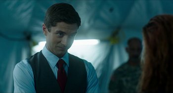 Movie still from “American Ultra” (2015), directed by Nima Nourizadeh – A man wearing a vest and a red tie; Close Up shot, Over the shoulder angle