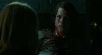 Movie still from “American Ultra” (2015), directed by Nima Nourizadeh – A man with a bloody face sitting next to a woman; Close Up shot, Over the shoulder angle