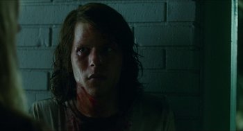 Movie still from “American Ultra” (2015), directed by Nima Nourizadeh – A person with a bloody face in front of a brick wall; Close Up shot, Low angle