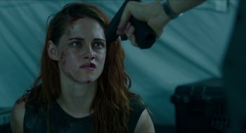 Movie still from “American Ultra” (2015), directed by Nima Nourizadeh – A woman is getting her hair cut by a man; Close Up shot, High angle