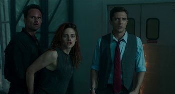 Movie still from “American Ultra” (2015), directed by Nima Nourizadeh – A man and a woman standing next to each other in a room; Medium shot, Low angle