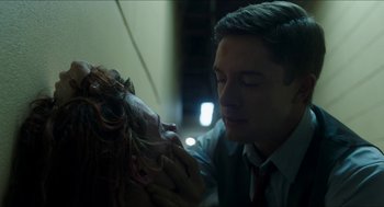 Movie still from “American Ultra” (2015), directed by Nima Nourizadeh – A man is holding the head of a creature; Close Up shot, Low angle