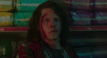 Movie still from “American Ultra” (2015), directed by Nima Nourizadeh – A young man with long hair and a bandage on his head; Close Up shot, Low angle