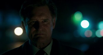 Movie still from “American Ultra” (2015), directed by Nima Nourizadeh – A person wearing a suit and tie; Close Up shot, Low angle