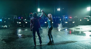 Movie still from “American Ultra” (2015), directed by Nima Nourizadeh – A couple of people standing in the middle of a street; Wide shot, Low angle