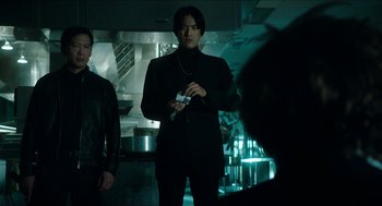 Movie still from “American Ultra” (2015), directed by Nima Nourizadeh – A man standing in a kitchen holding a nintendo wii game controller; Medium shot, Low angle