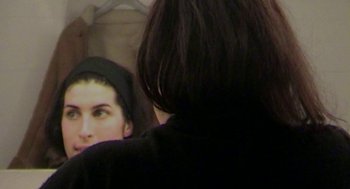Movie still from “Amy” (2015), directed by Asif Kapadia – A woman in a black hoodie looking at another woman in a black hoodie; Close Up shot, High angle