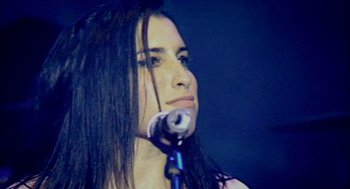 Movie still from “Amy” (2015), directed by Asif Kapadia – A person holding a microphone; Close Up shot, Low angle