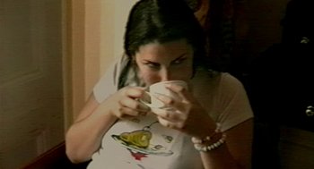 Movie still from “Amy” (2015), directed by Asif Kapadia – A woman is drinking a cup of coffee; Close Up shot, High angle