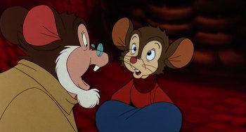 Movie still from “An American Tail” (1986), directed by Don Bluth – A couple of people that are sitting down together; Close Up shot, High angle