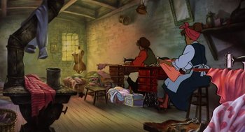 Movie still from “An American Tail” (1986), directed by Don Bluth – Two women sitting at a table in a room with luggage; Wide shot, High angle