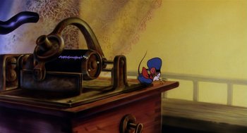 Movie still from “An American Tail” (1986), directed by Don Bluth – An animated mouse sitting on top of an old phonograph record player; Medium shot, High angle