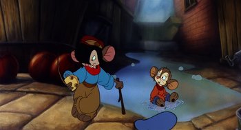 Movie still from “An American Tail” (1986), directed by Don Bluth – A cartoon of a mouse holding a stick in front of another mouse in a puddle; Wide shot, High angle