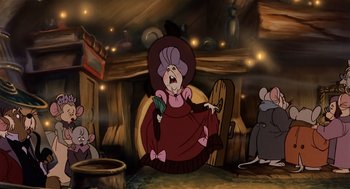 Movie still from “An American Tail” (1986), directed by Don Bluth – A group of cartoon mice sitting in front of a fireplace; Medium shot, Over the shoulder angle