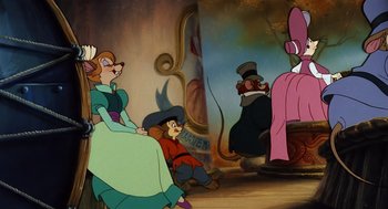 Movie still from “An American Tail” (1986), directed by Don Bluth – A group of people sitting in a room; Wide shot, Over the shoulder angle