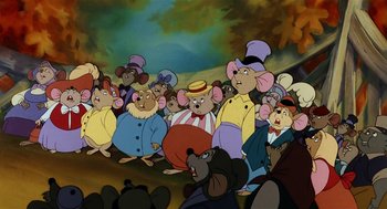 Movie still from “An American Tail” (1986), directed by Don Bluth – A group of mice are gathered together in a crowd; Medium shot, High angle