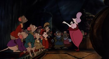Movie still from “An American Tail” (1986), directed by Don Bluth – A crowd of people watching a woman in a pink dress; Wide shot, Over the shoulder angle