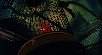 Movie still from “An American Tail” (1986), directed by Don Bluth – A mouse in a red shirt in front of a bird cage; Wide shot, Low angle