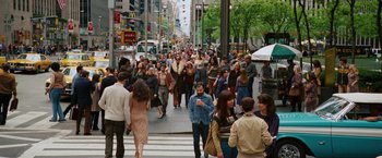 Movie still from “Anchorman 2: The Legend Continues” (2013), directed by Adam McKay – A crowd of people walking across a street; Wide shot, High angle