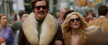 Movie still from “Anchorman 2: The Legend Continues” (2013), directed by Adam McKay – A man and a woman walking down a street; Medium shot, Low angle