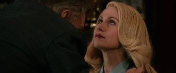 Movie still from “Anchorman 2: The Legend Continues” (2013), directed by Adam McKay – A woman with blonde hair is looking up at a man; Close Up shot, Over the shoulder angle