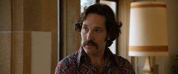 Movie still from “Anchorman 2: The Legend Continues” (2013), directed by Adam McKay – A person wearing a shirt; Close Up shot, Over the shoulder angle