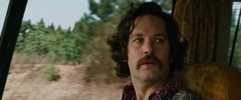 Movie still from “Anchorman 2: The Legend Continues” (2013), directed by Adam McKay – A person with a beard and a mustache; Close Up shot, Low angle