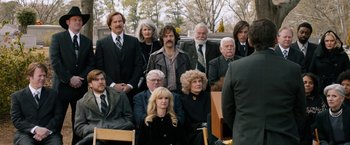 Movie still from “Anchorman 2: The Legend Continues” (2013), directed by Adam McKay – A group of people sitting in front of a van; Wide shot, High angle