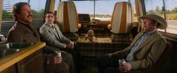 Movie still from “Anchorman 2: The Legend Continues” (2013), directed by Adam McKay – Two men and a dog sitting in a bus; Wide shot, High angle