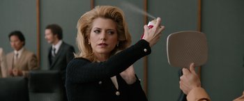 Movie still from “Anchorman 2: The Legend Continues” (2013), directed by Adam McKay – A woman with a hair spray in her hand; Close Up shot, Over the shoulder angle