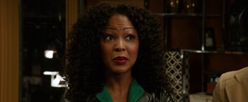 Movie still from “Anchorman 2: The Legend Continues” (2013), directed by Adam McKay – A person with curly black hair; Close Up shot, Over the shoulder angle