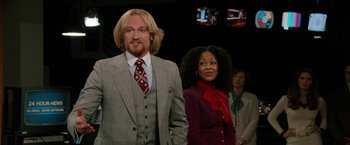 Movie still from “Anchorman 2: The Legend Continues” (2013), directed by Adam McKay – A man and a woman standing next to each other; Medium shot, Low angle