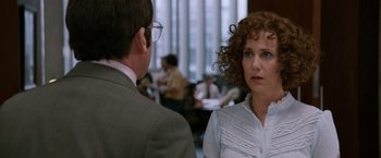 Movie still from “Anchorman 2: The Legend Continues” (2013), directed by Adam McKay – A woman in a white shirt and a man in a gray suit; Close Up shot, Over the shoulder angle