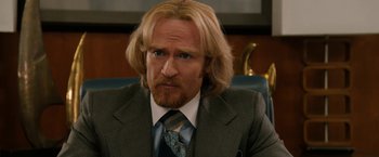 Movie still from “Anchorman 2: The Legend Continues” (2013), directed by Adam McKay – A person wearing a suit and tie; Close Up shot, Over the shoulder angle
